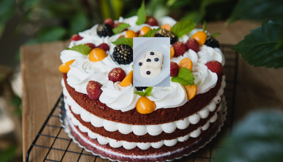 Soft and fluffy homemade vanilla cake on a cooling rack, decorated with buttercream frosting and fresh berries.