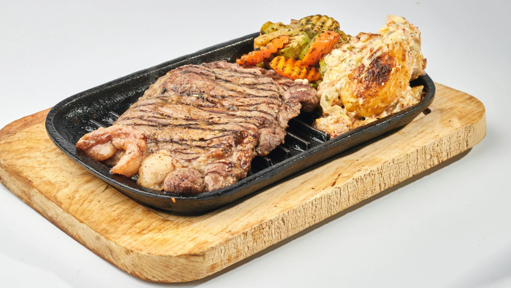 Traditional British Sunday Roast with roast beef, golden roast potatoes, Yorkshire pudding, vegetables, and rich gravy on a wooden table"