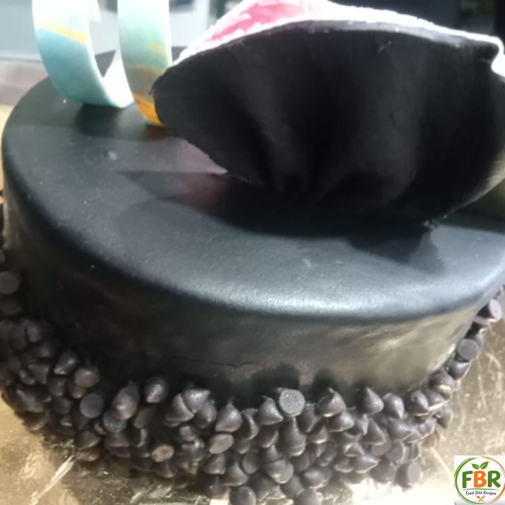 homemade chocolate fridge cake with chocolate ganache and chocolate chip decoration