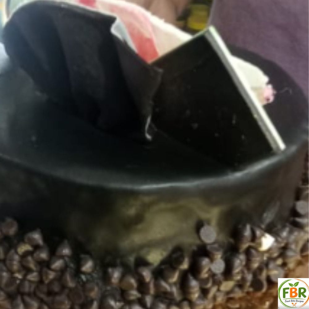 chocolate fridge cake served on a white plate with cocoa powder dusting