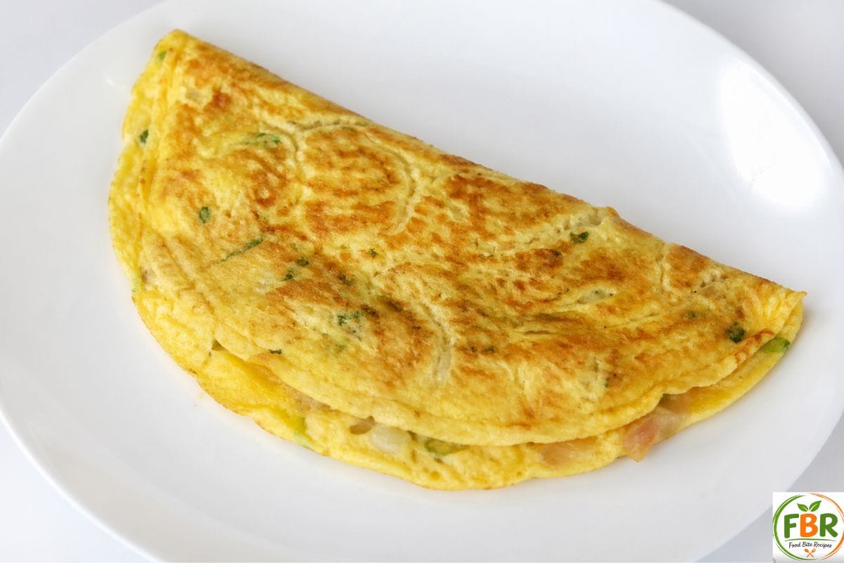 fluffy homemade omelet served on a clean white plate