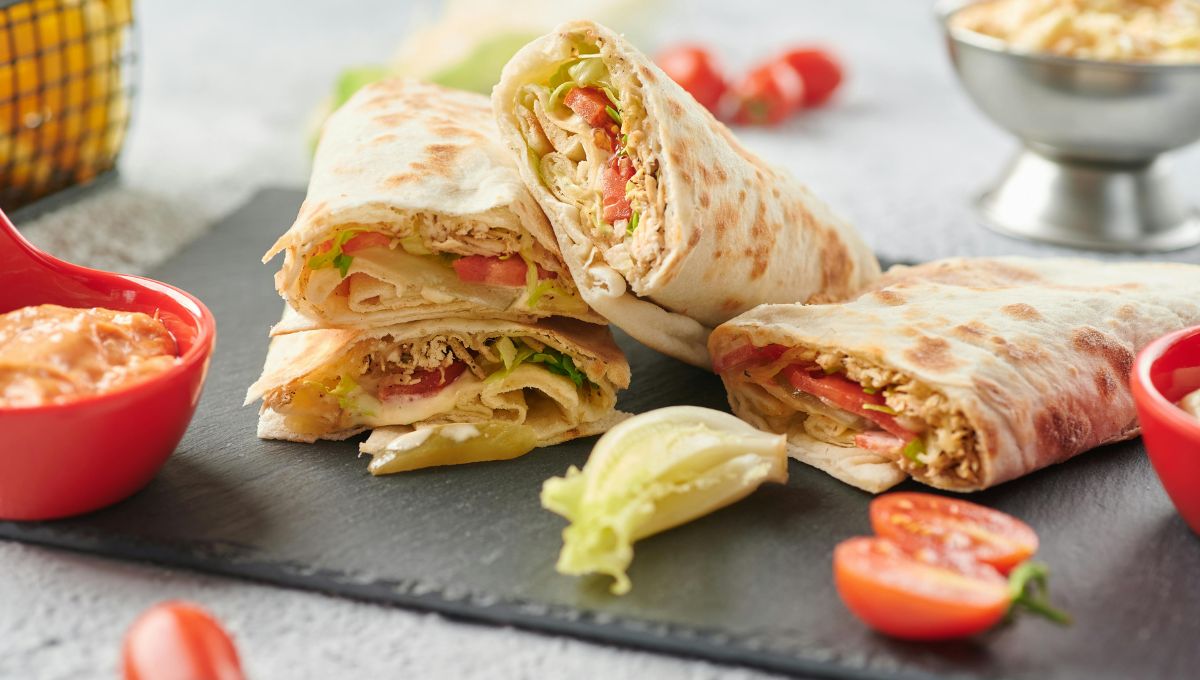 Chicken Shawarma Wrap on a plate with fresh vegetables and garlic sauce"