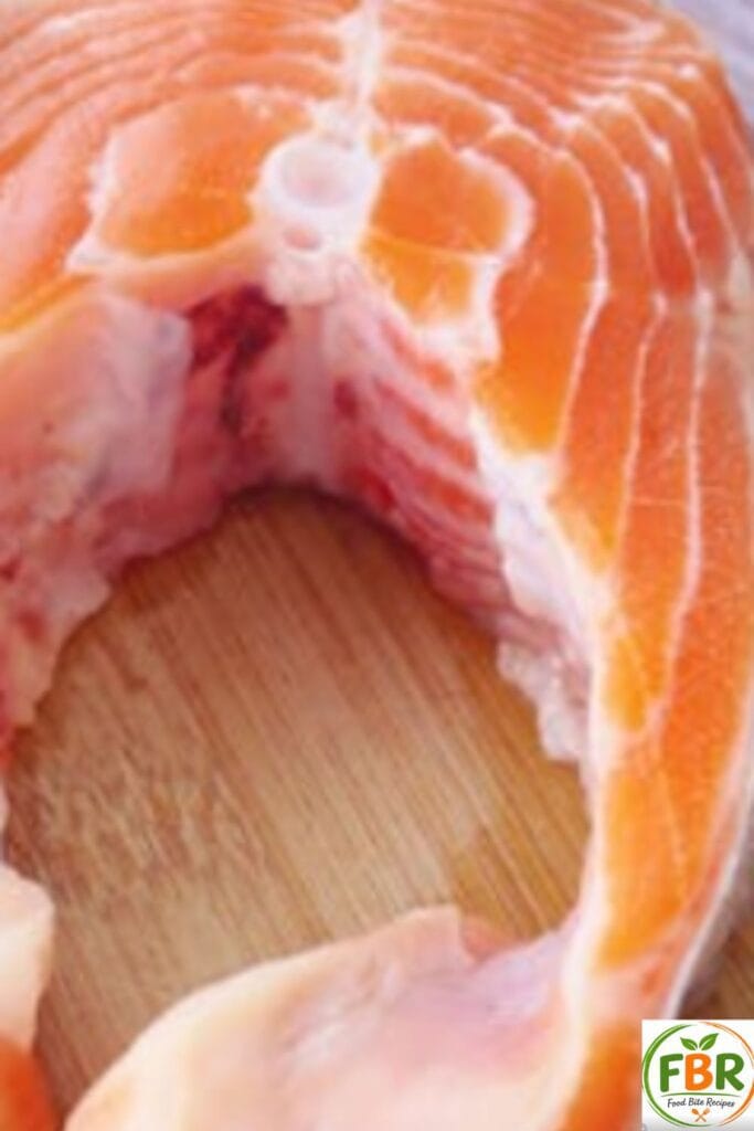 fresh raw salmon fillet on a wooden cutting board