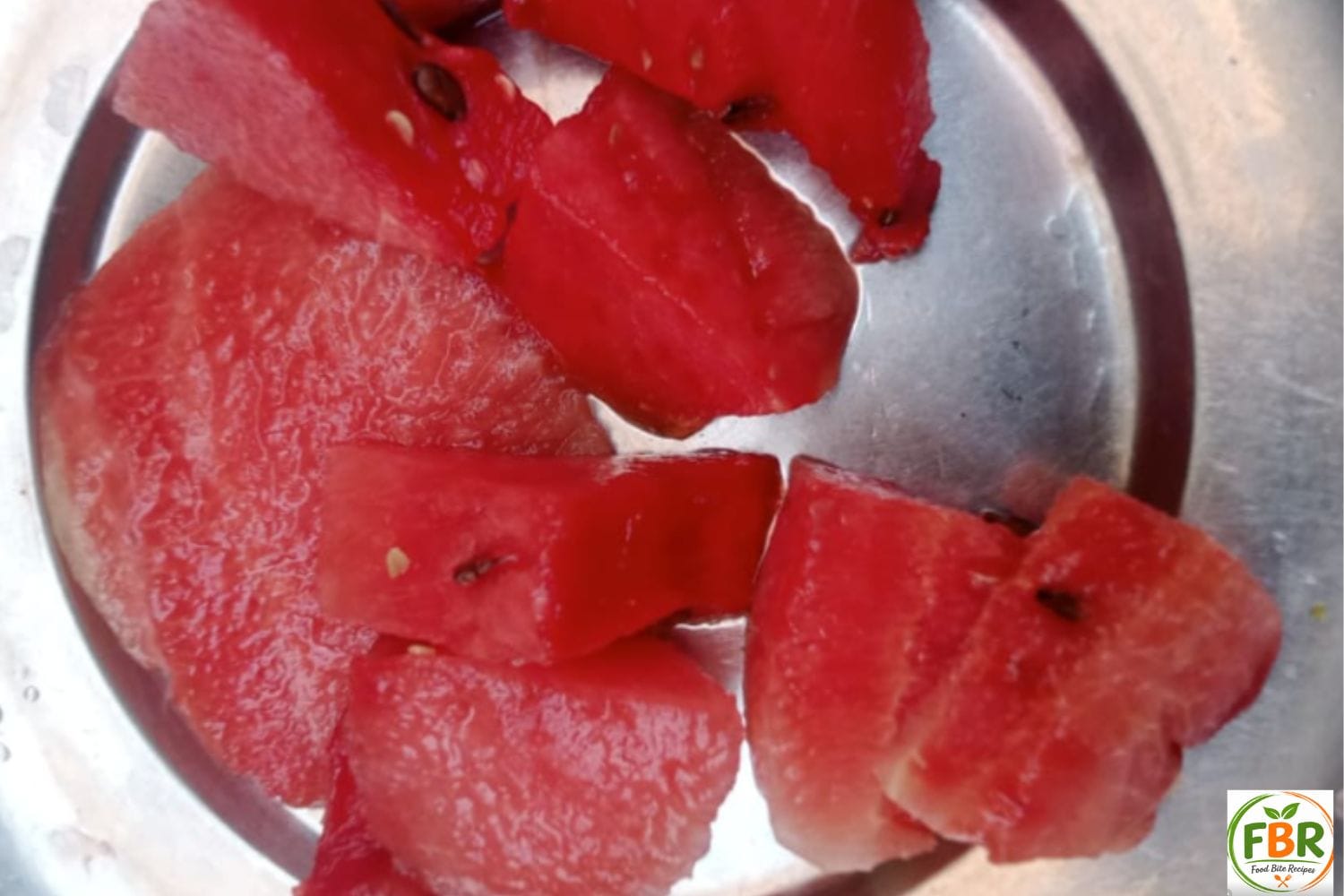 Freshly cut red watermelon chunks on a plate for making juice