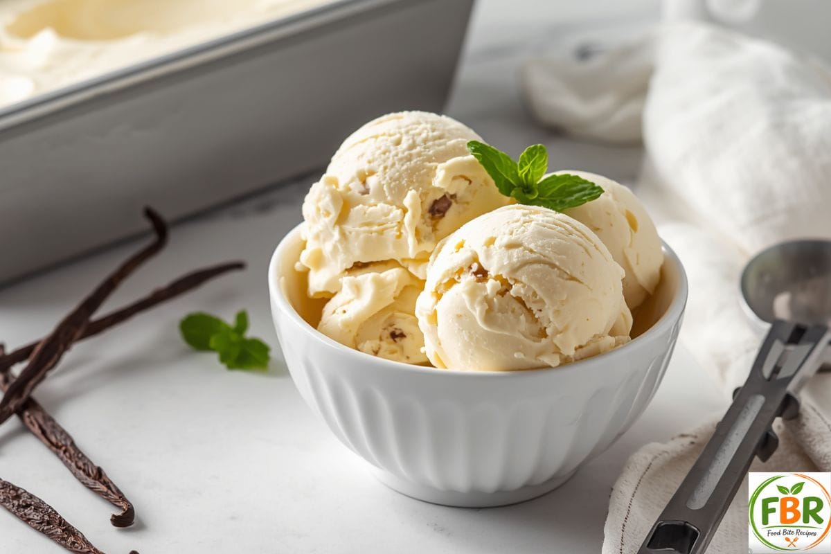 Homemade vanilla ice cream without a machine served in a bowl with three creamy scoops