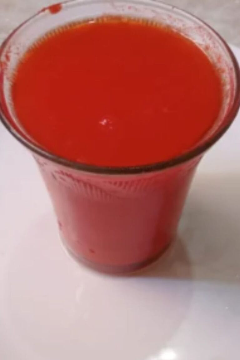 Homemade watermelon juice served in a glass on a white plate