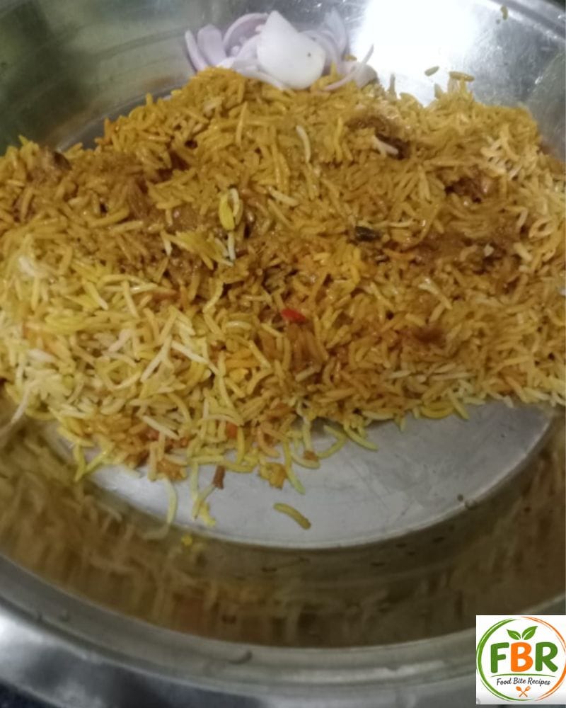 Serving chicken biryani with raita and salad on plate