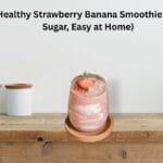 Healthy Strawberry Banana Smoothie without sugar in a glass on a wooden table.