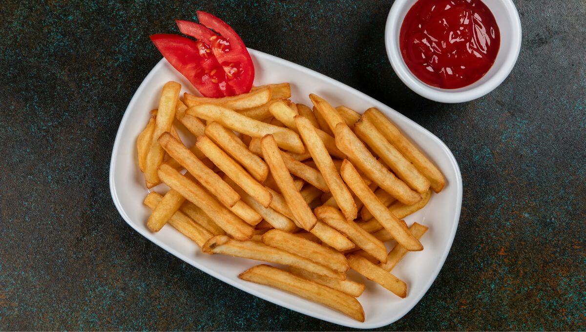 Crispy golden air fryer frozen French fries served with tomato