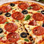 Keto Pizza with crispy low-carb fathead dough crust topped with cheese and pepperoni