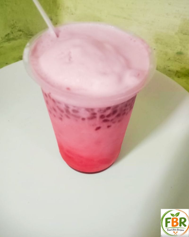 Serving glass of homemade kulfi falooda with basil seeds and rose milk